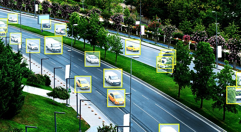 Bounding-box annotations over a traffic scene — vehicles and pedestrians labeled for downstream training.